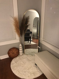Haven arched freestanding floor mirror in bedroom — Bask Decor Pakistan